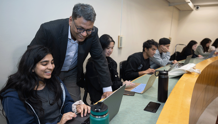 Nitin Aggarwal with his students from the AI in Business class. Photo by Jim Gensheimer.